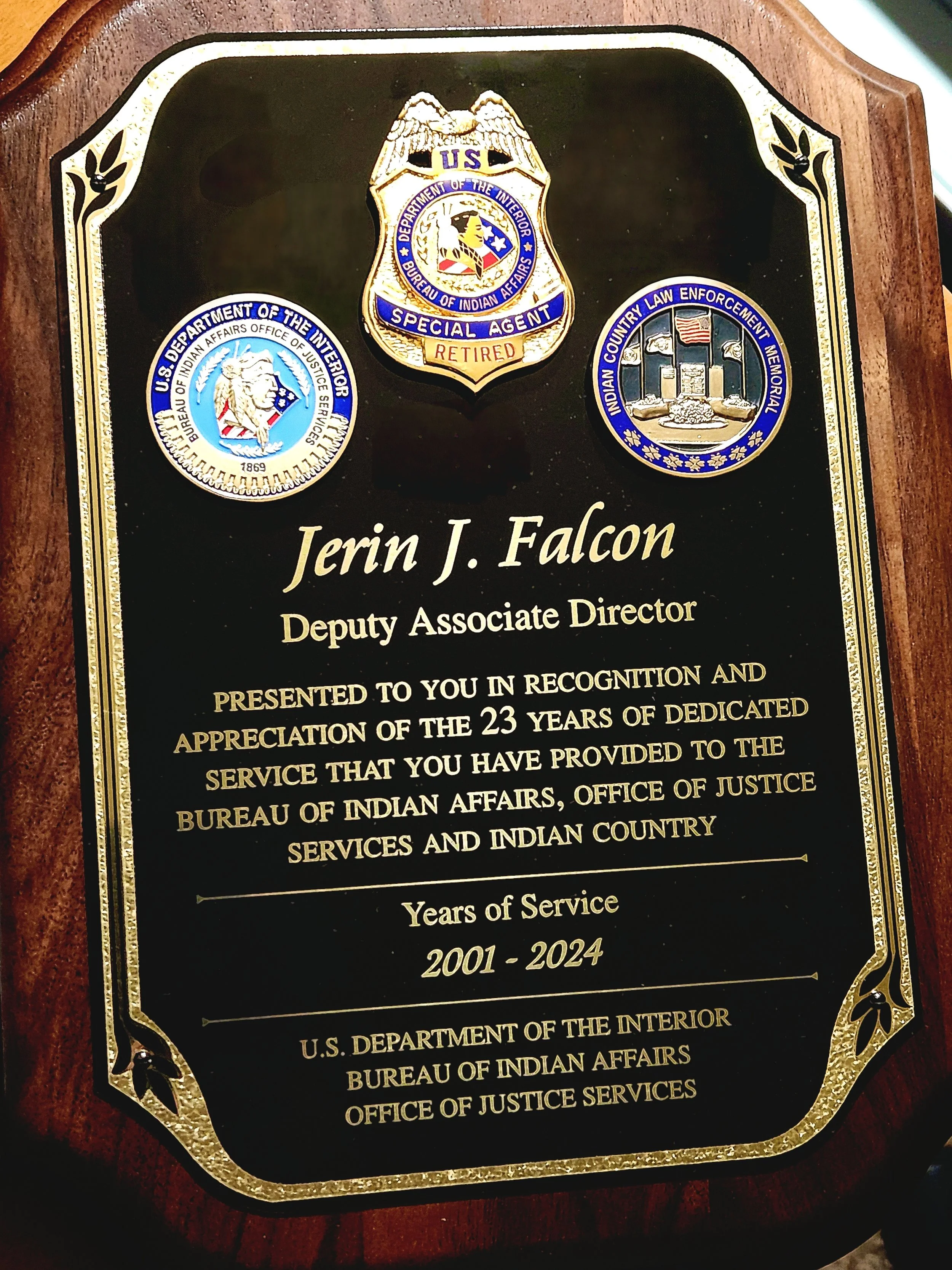 Retirement plaque honoring Jerin Falcon's federal service with the Bureau of Indian Affairs Office of Justice Services.