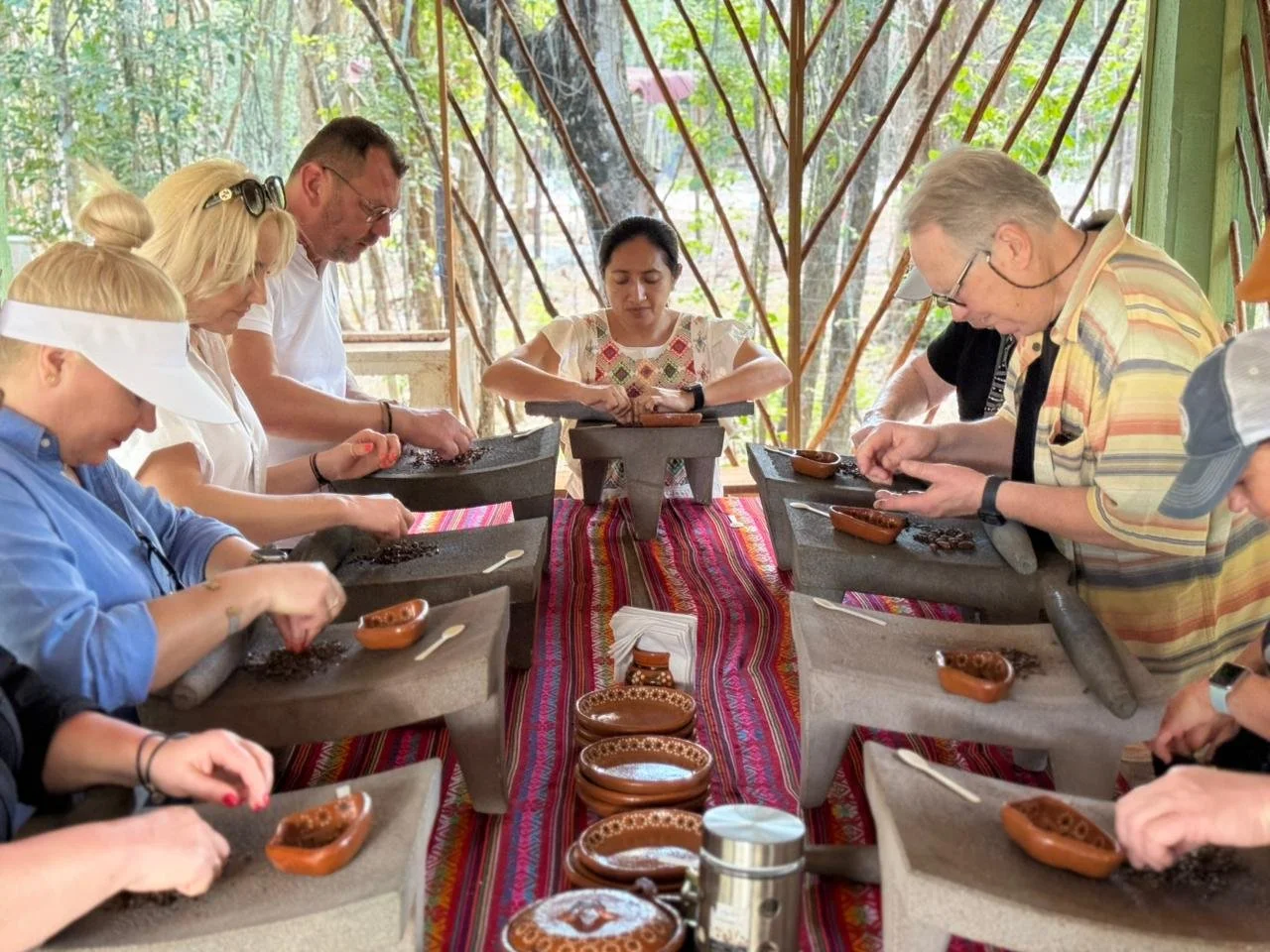 Grinding cacao beans on volcanic stone to make Mayan chocolate