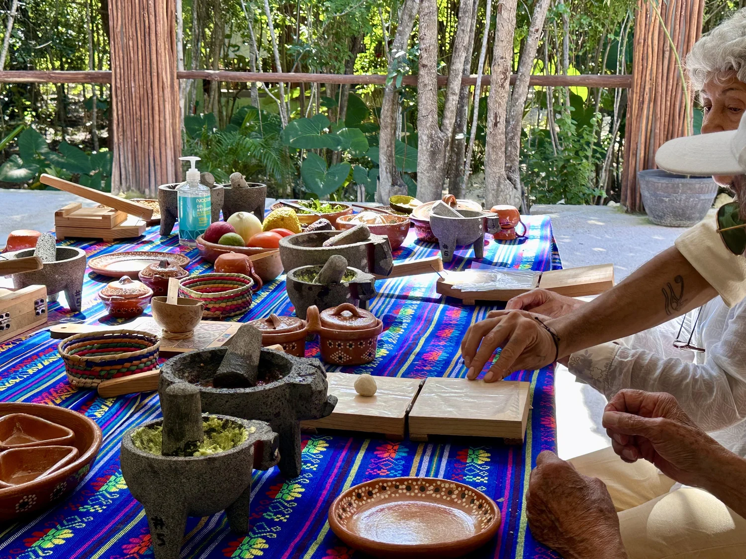 Grinding pumpkin-seed salsa in a volcanic stone molcajete