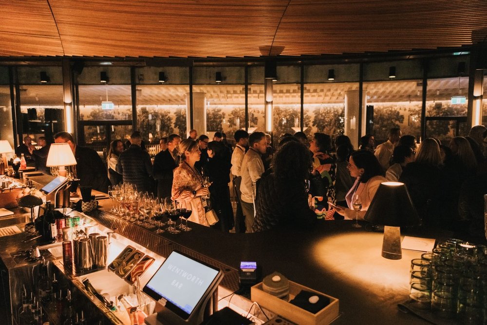The launch party in full swing around a round, timber-ceilinged bar