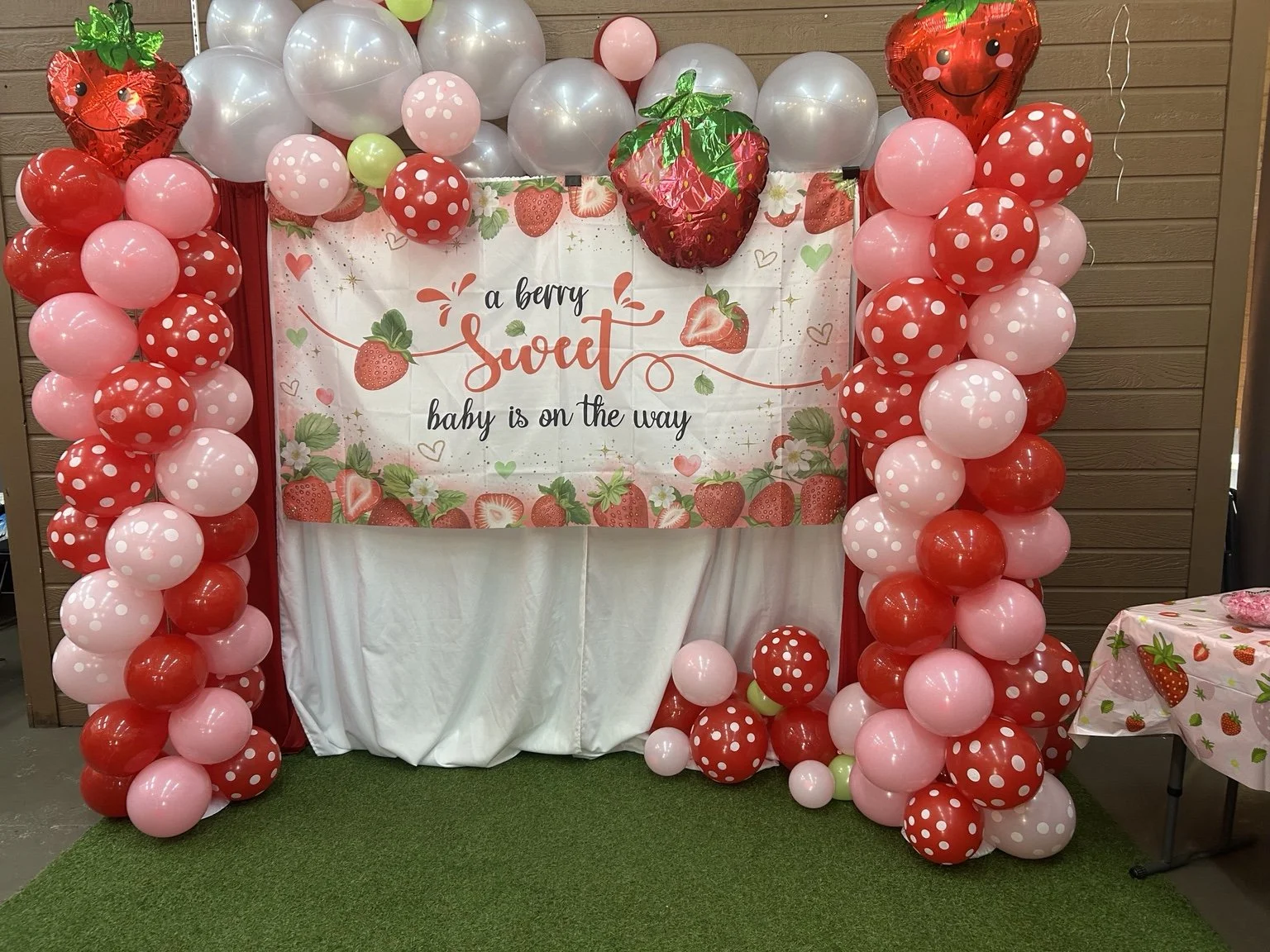 Strawberry-themed balloon backdrop at a past baby shower hosted at Miracles On Main Sono