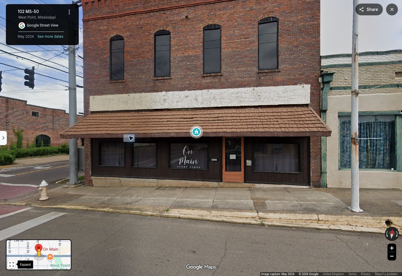 Front of the brick On Main building at 26381 East Main Street in West Point, Mississippi; studio entrance is at the rear off Division Street