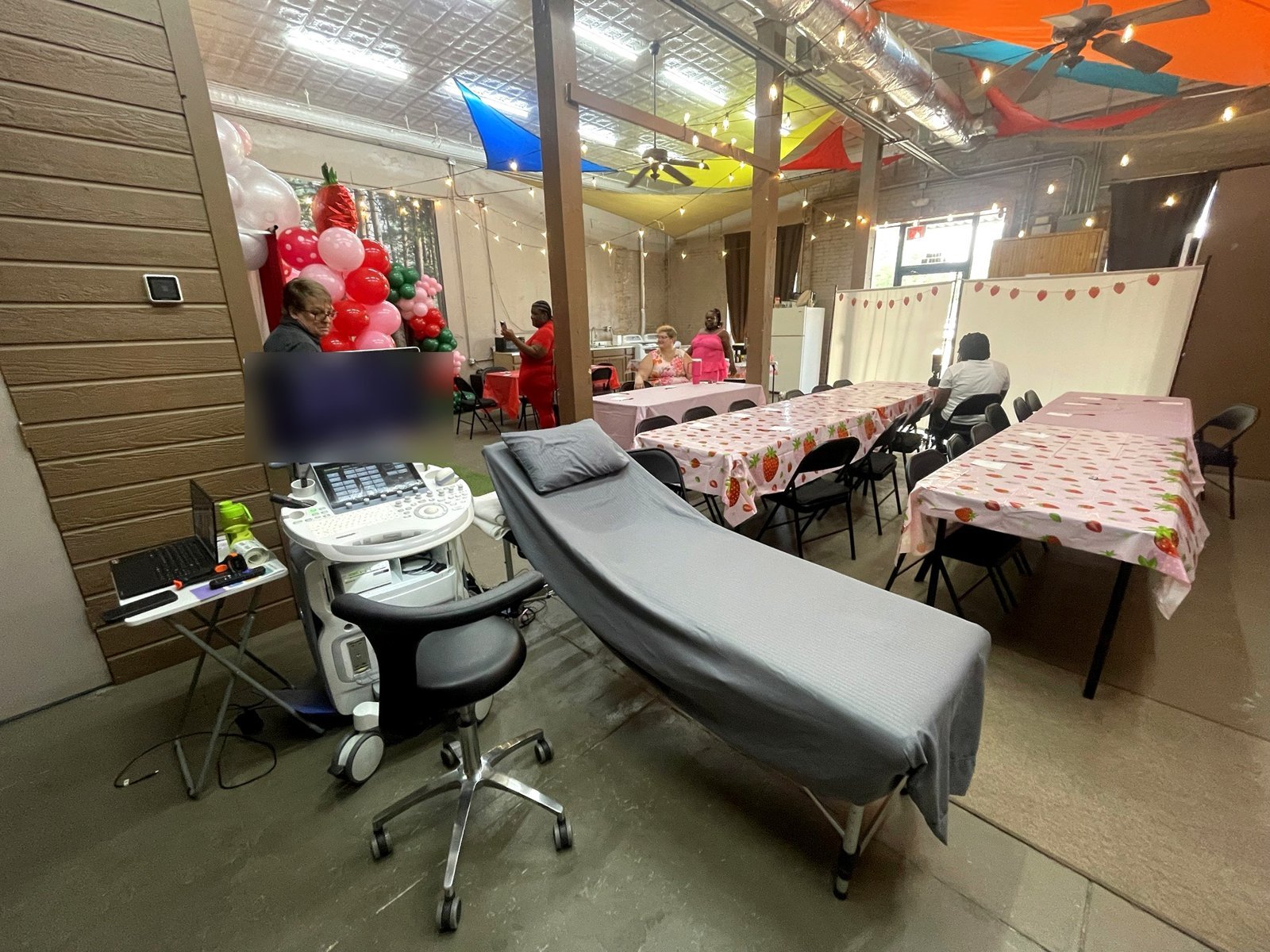 Ultrasound station set up beside guest tables for a baby shower at Miracles On Main Sono in West Point, MS