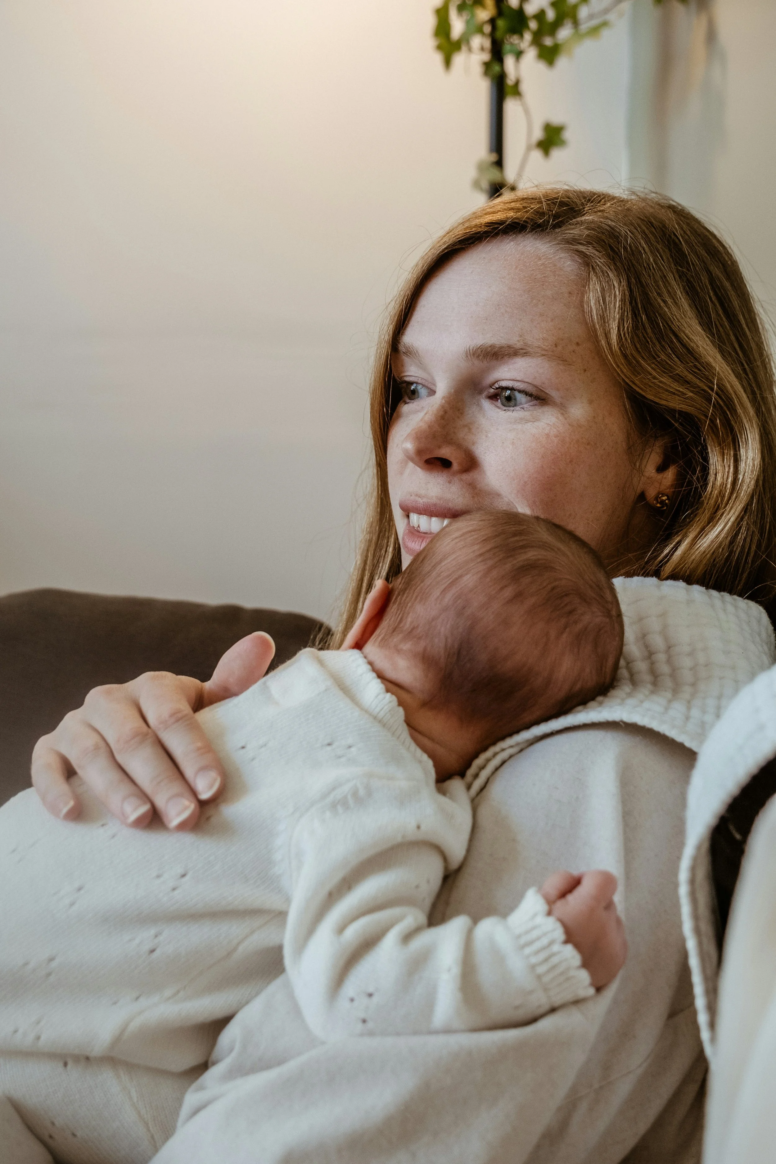 A mother holding her newborn close