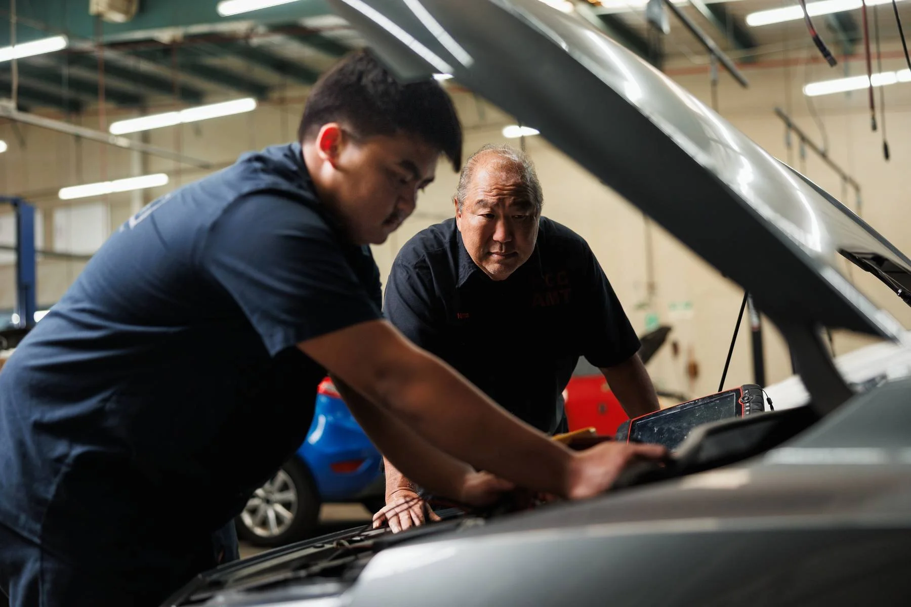 Automotive instructor working with students