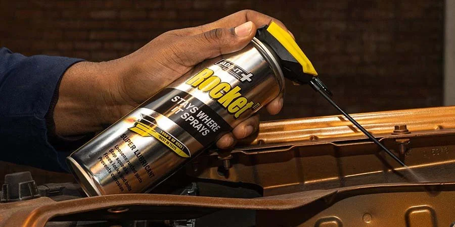 Rocket TT Super Lubricant Spraying Onto Stuck Bolt In A Cars Engine Bay