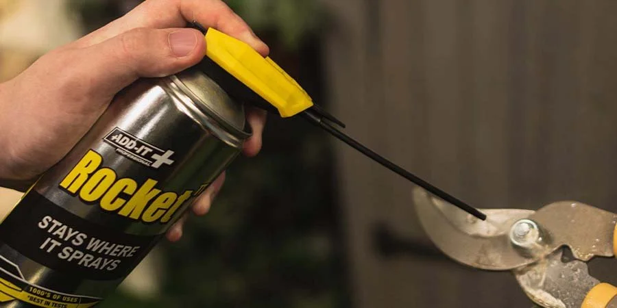 Rocket TT Super Lubricant Spraying Onto Garden Tool
