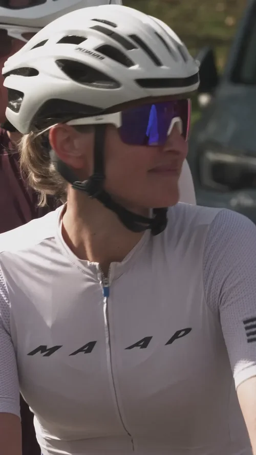 A rider in sunglasses and helmet waiting at the start
