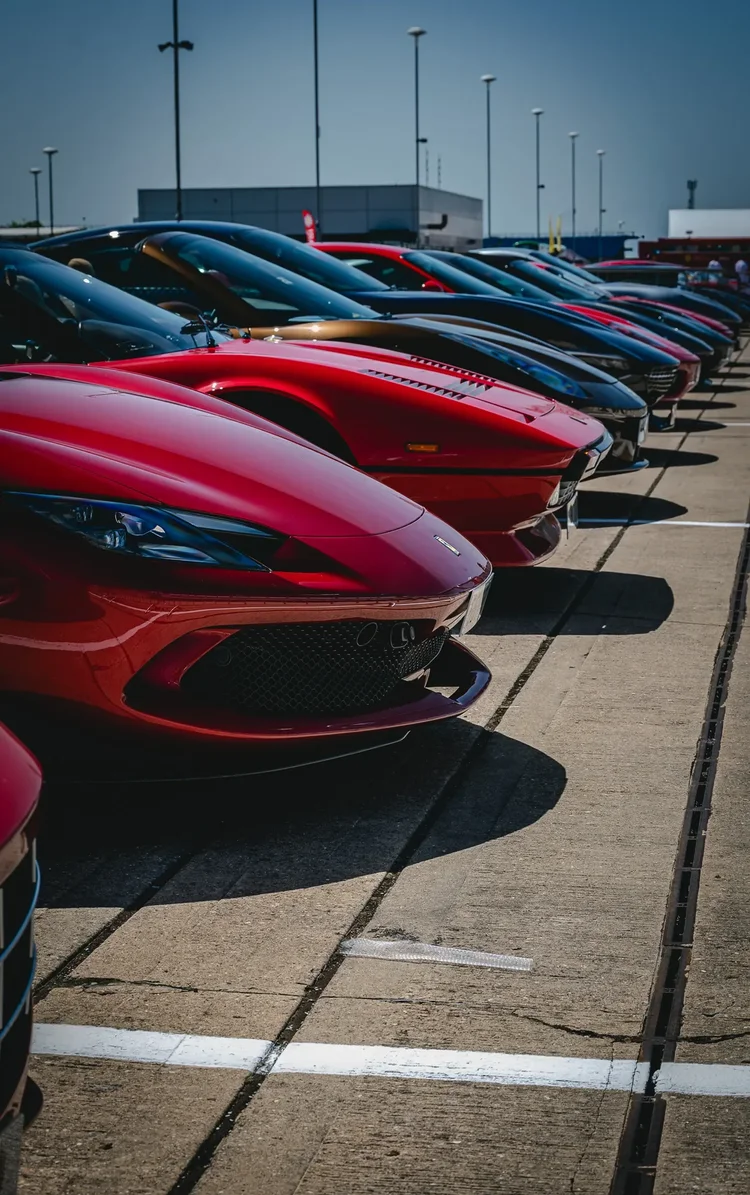 A line of sports cars running to the horizon
