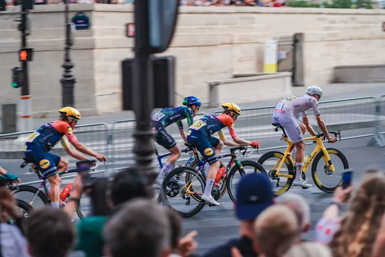 Lidl-Trek and Soudal Quick-Step riders following a UAE rider on a yellow Colnago, Tour de France 2026 final stage