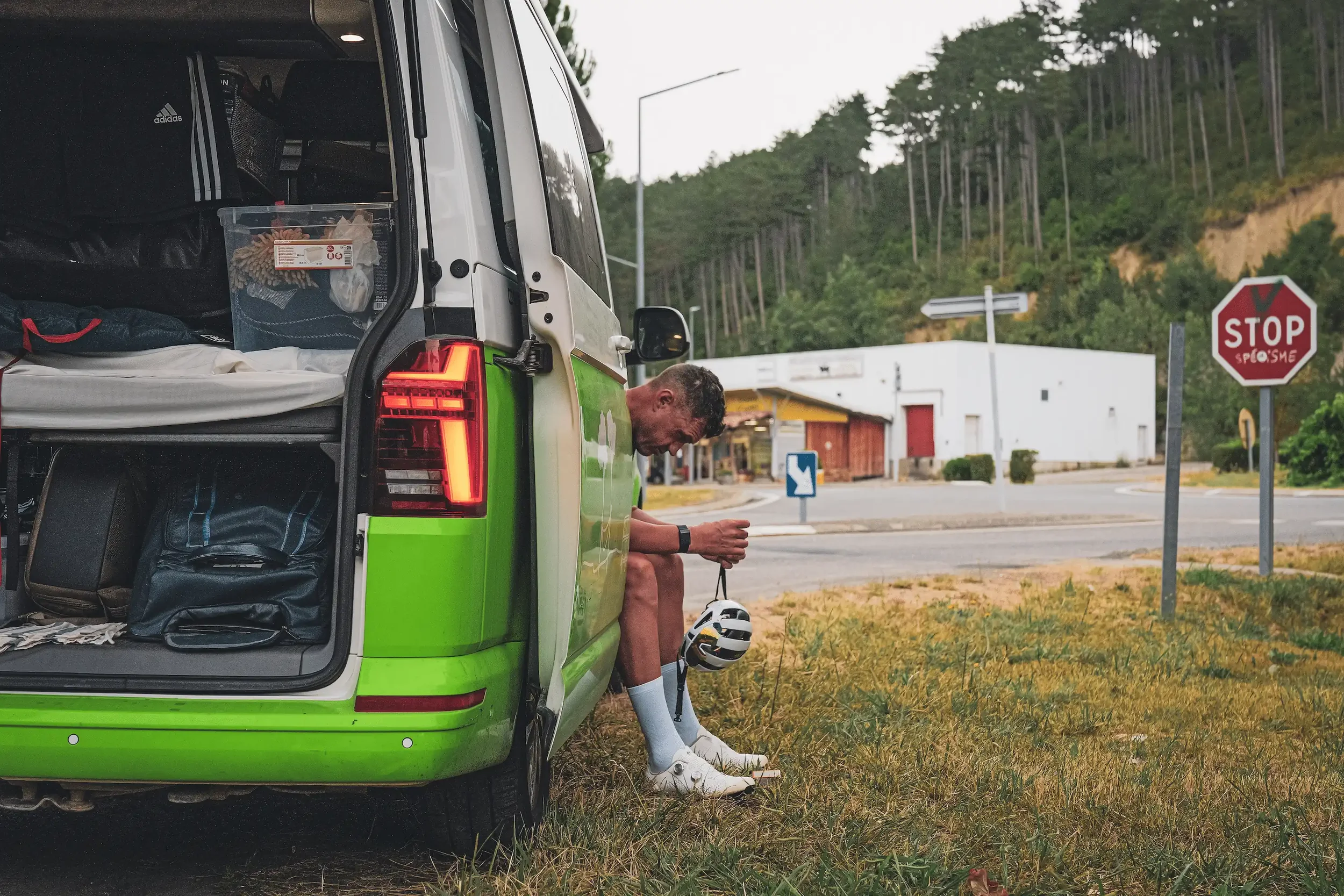 Rider resting in the back of the support campervan between stages on the 2112 Tour de France ride