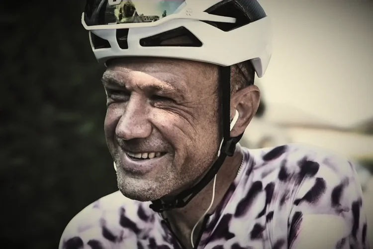 James laughing in a patterned jersey, hand-tinted portrait