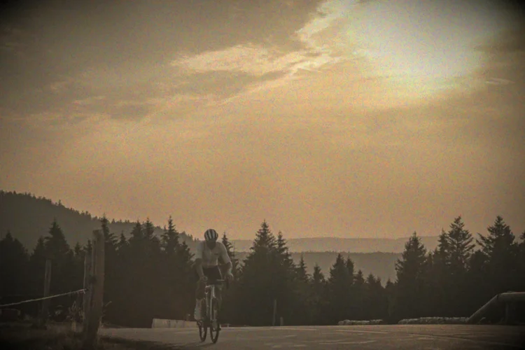 A rider at sunset on a mountain road