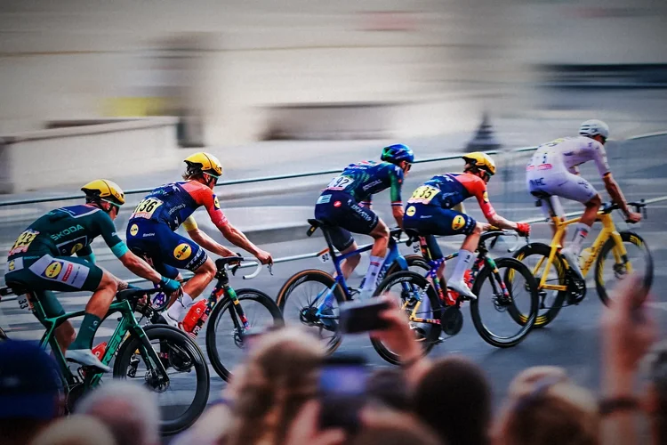 A line of riders through a Paris corner in streaked colour