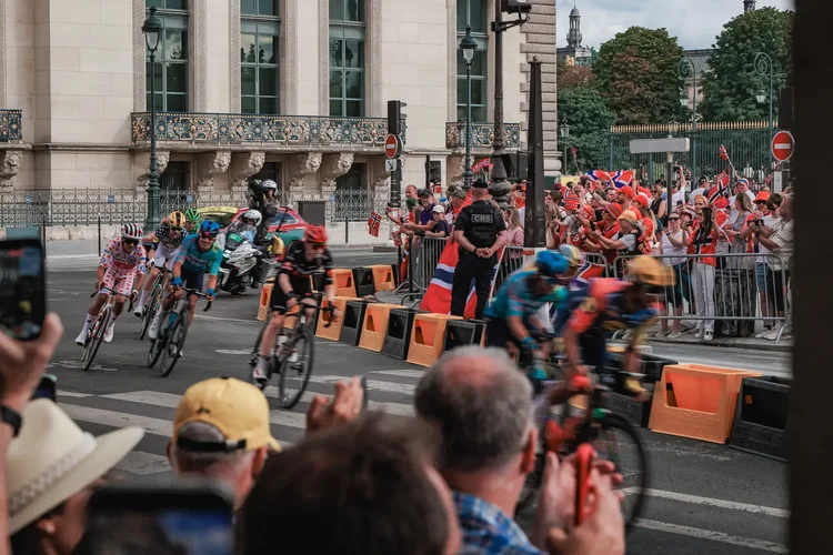 The polka dot jersey leading a group past the crowd on the final stage of the Tour de France 2026