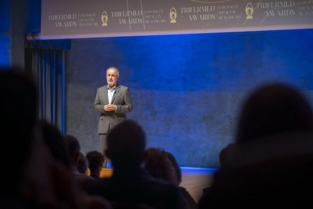 Sergi on stage in a focused institutional moment