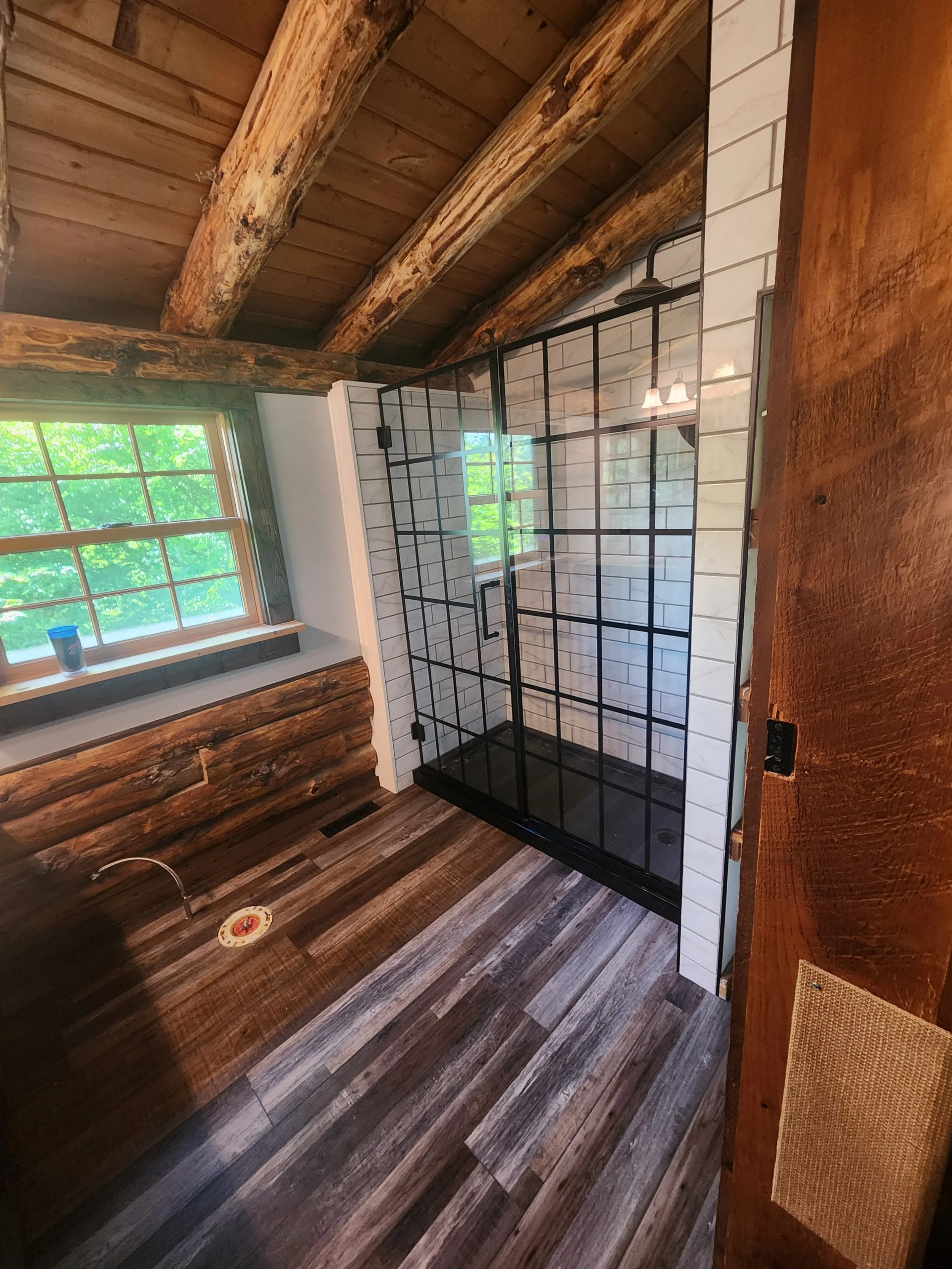 Log cabin bathroom — shower and door angle