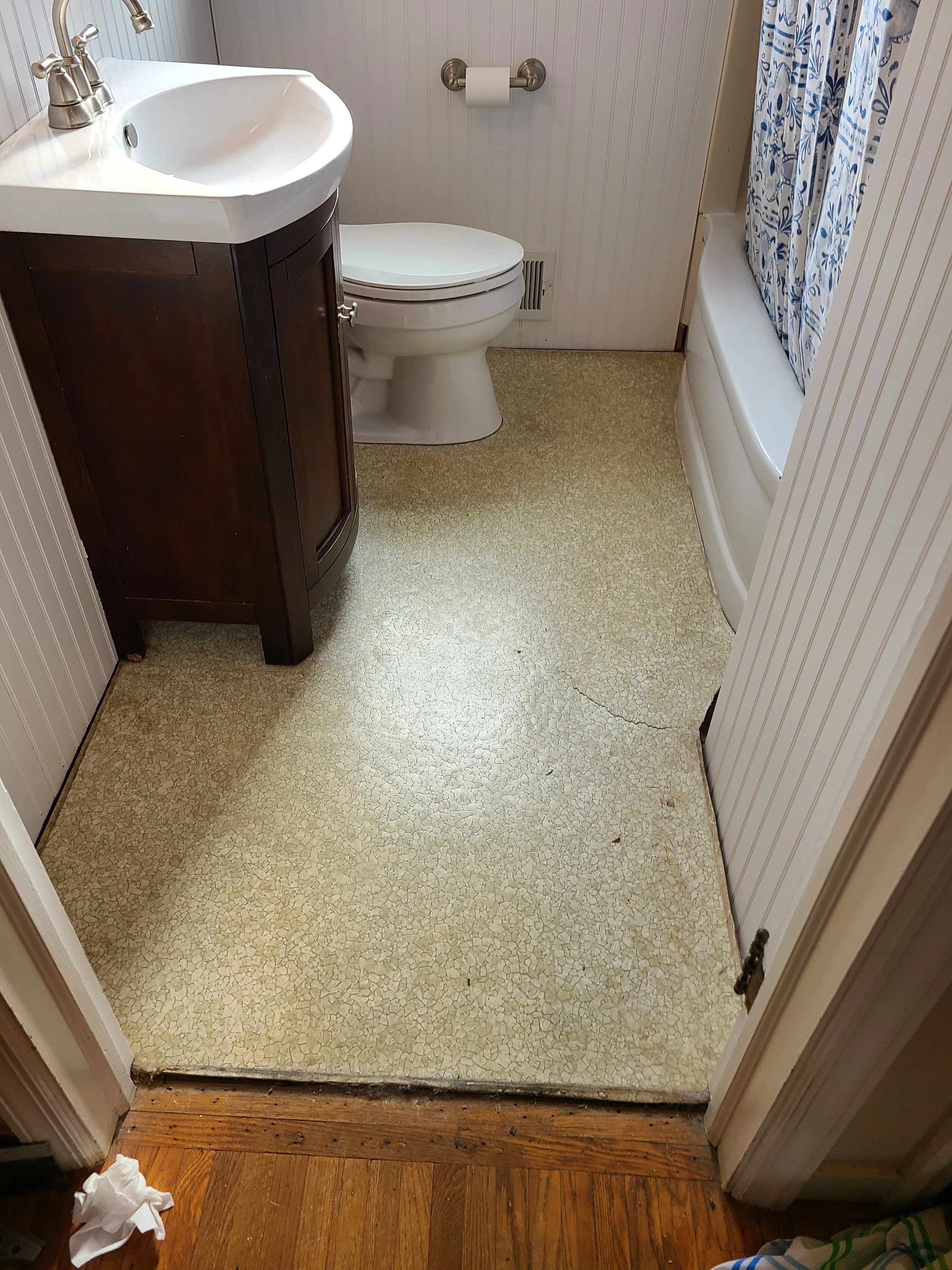 Bathroom floor before — cracked linoleum