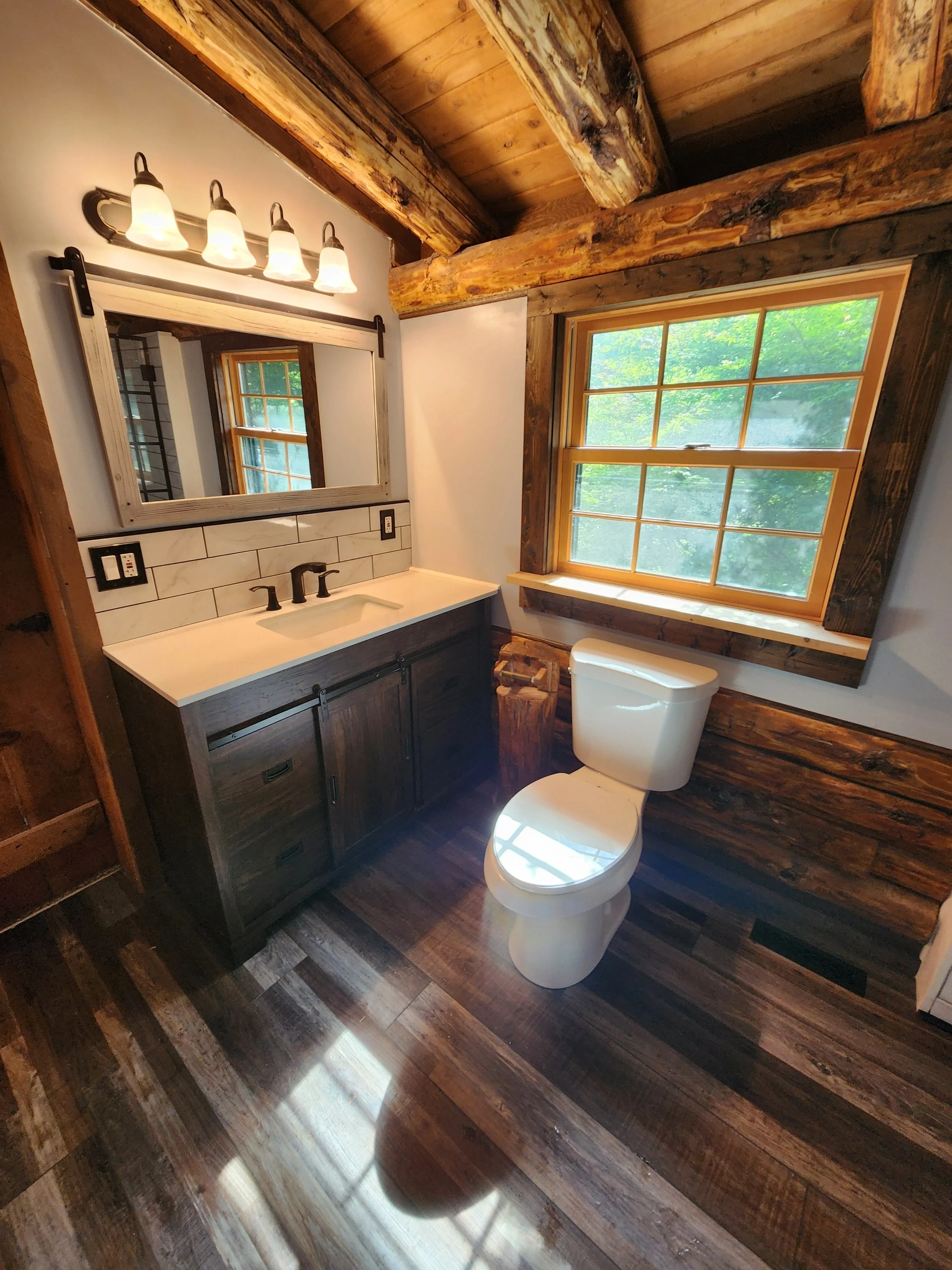 Log cabin bathroom — vanity and barn door