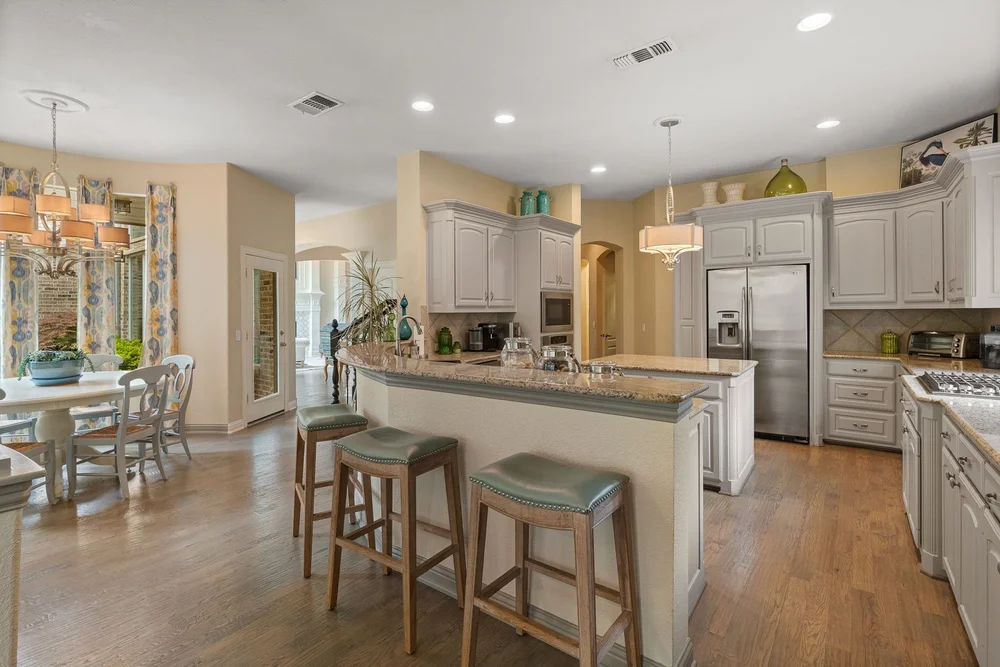 Open kitchen with a breakfast bar and hardwood flooring