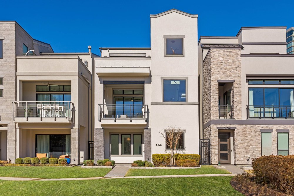 Modern townhome exteriors with balconies and stone accents