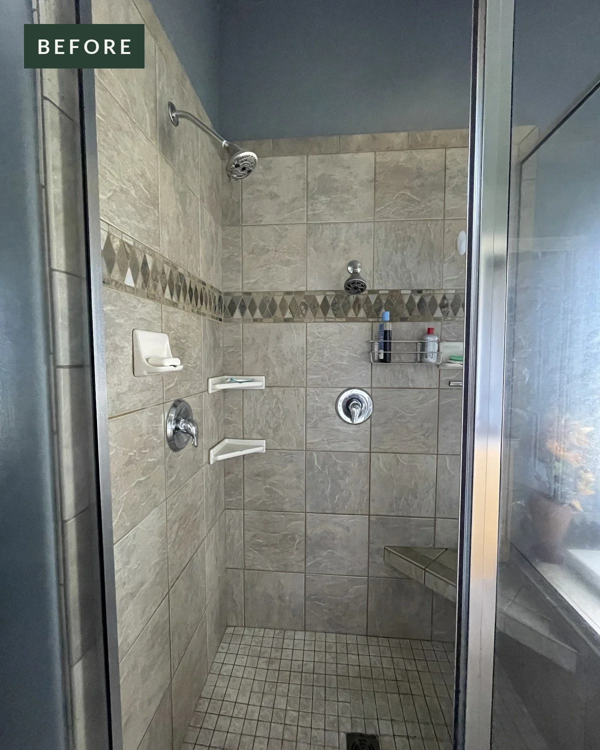 The same tiled walk-in shower before the grab bars were installed