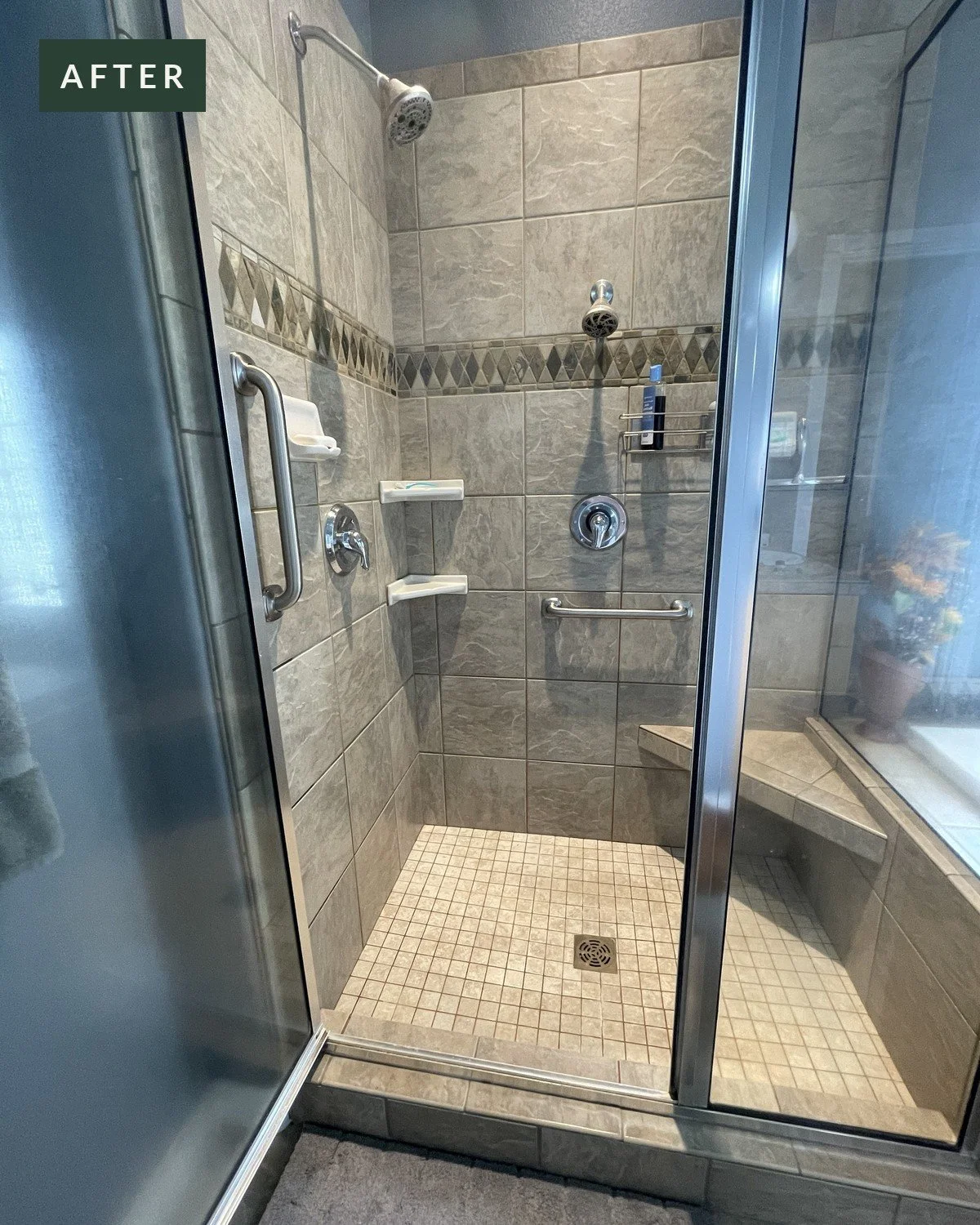 Tiled walk-in shower after two grab bars were installed, at the entry and along the back wall