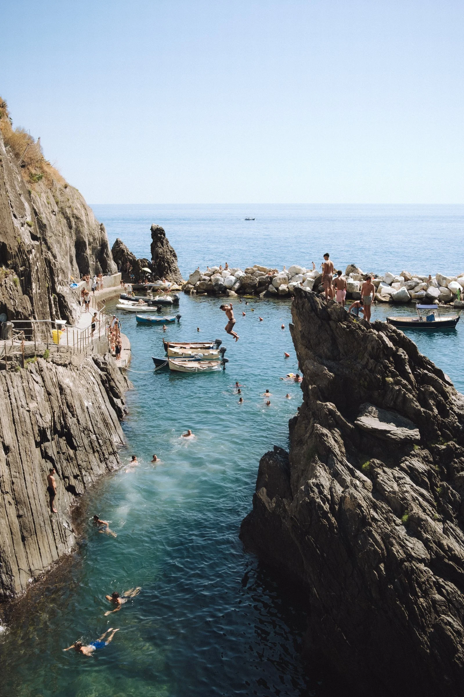 Cliff jumping into the Riomaggiore swimming cove, Cinque Terre