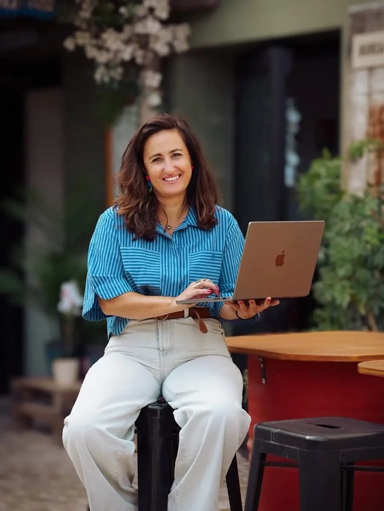 Christelle Sérou, souriante, assise avec son ordinateur portable
