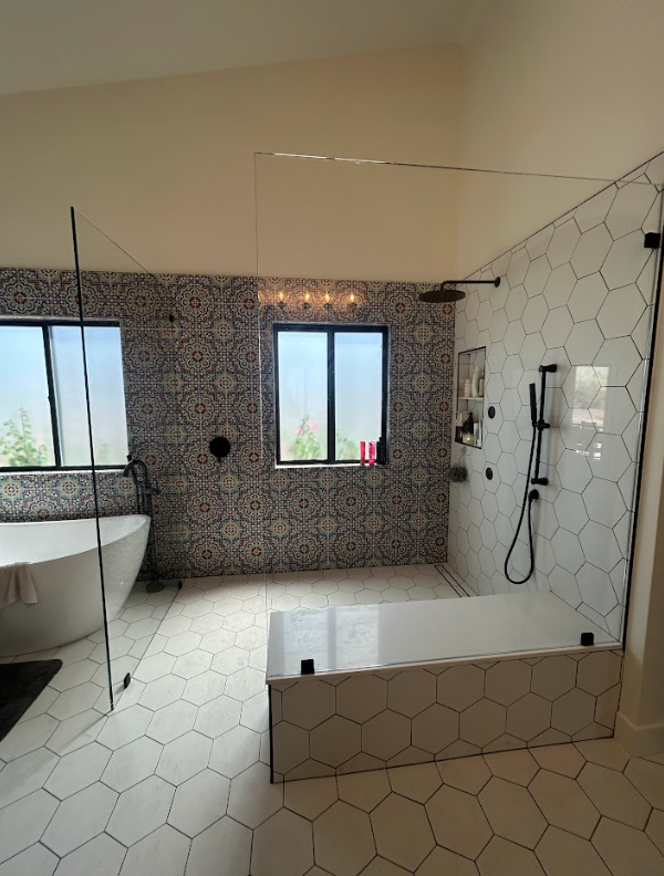 Frameless shower door enclosure installed in a modern bathroom