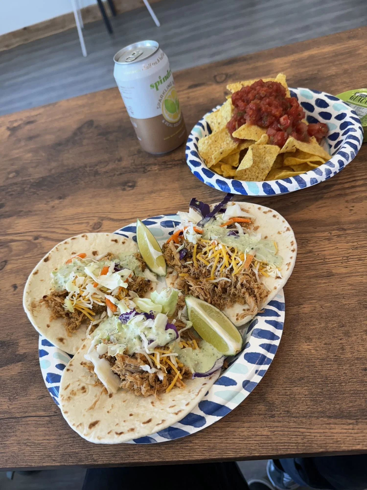 Plate of tacos and chips with salsa on a wooden table at XOverland Ranch near Bozeman, Montana