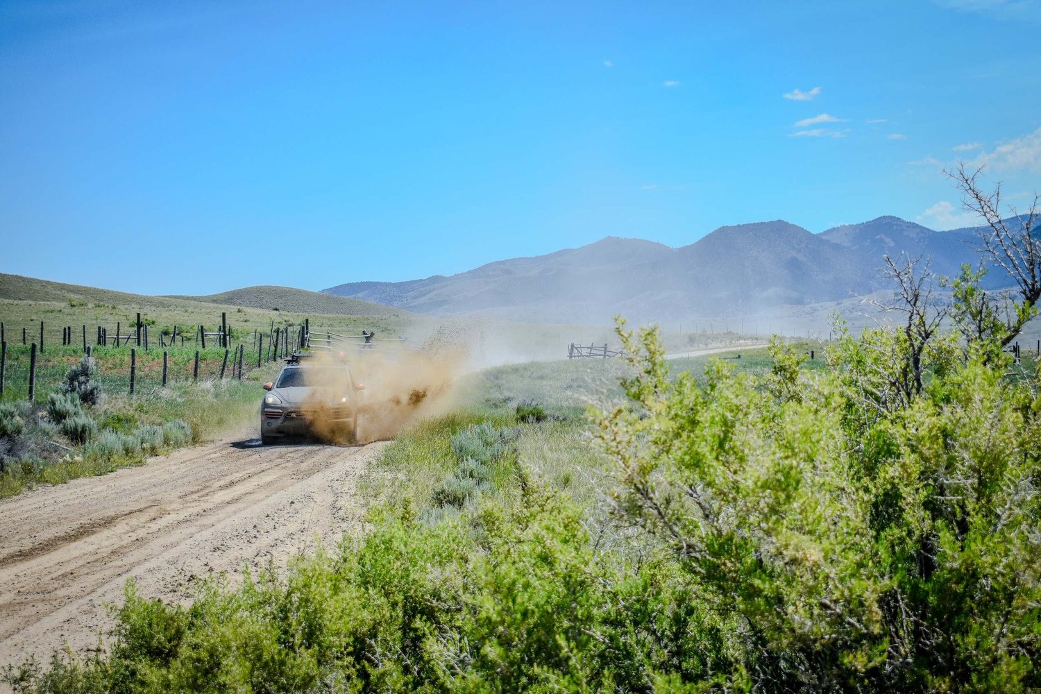 Rally vehicle nearly hidden inside a large dust cloud