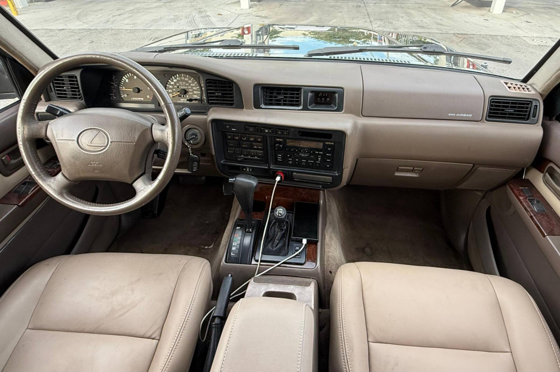 Beige leather interior and dashboard of the black 1997 Lexus LX450