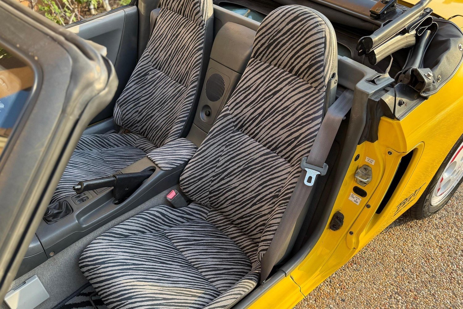 Zebra-print cloth seats in the Carnival Yellow 1991 Honda Beat