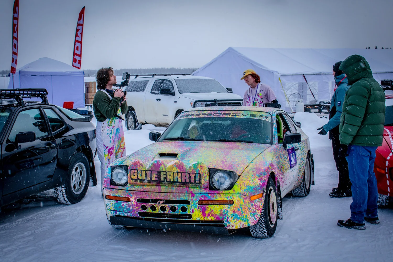 Porsche 944 with paint-splatter livery in the paddock at the Frost and Furious ice races in West Yellowstone
