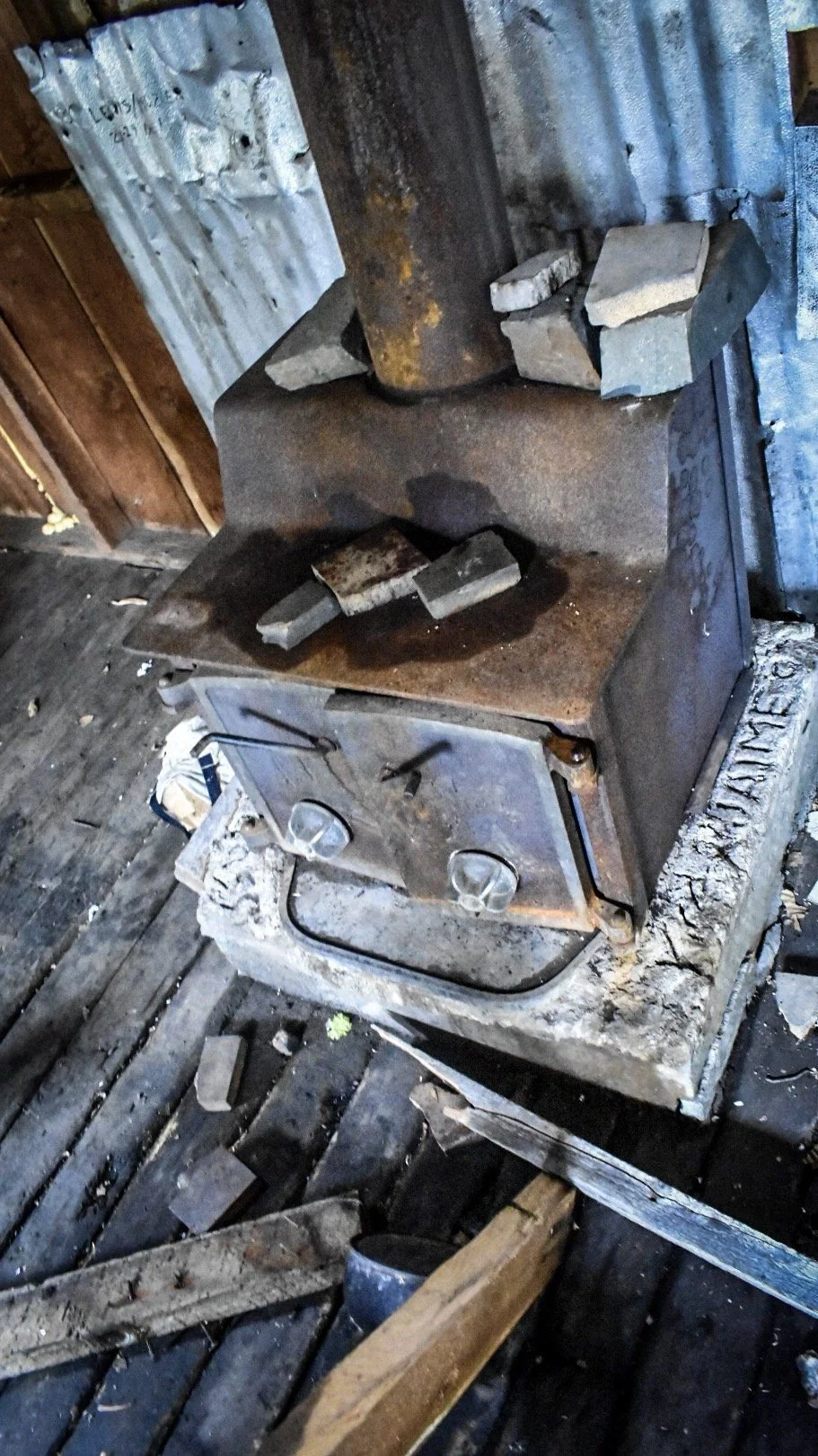 Old iron stove inside a weathered wooden cabin in the Elkhorn Mountains near Boulder, Montana