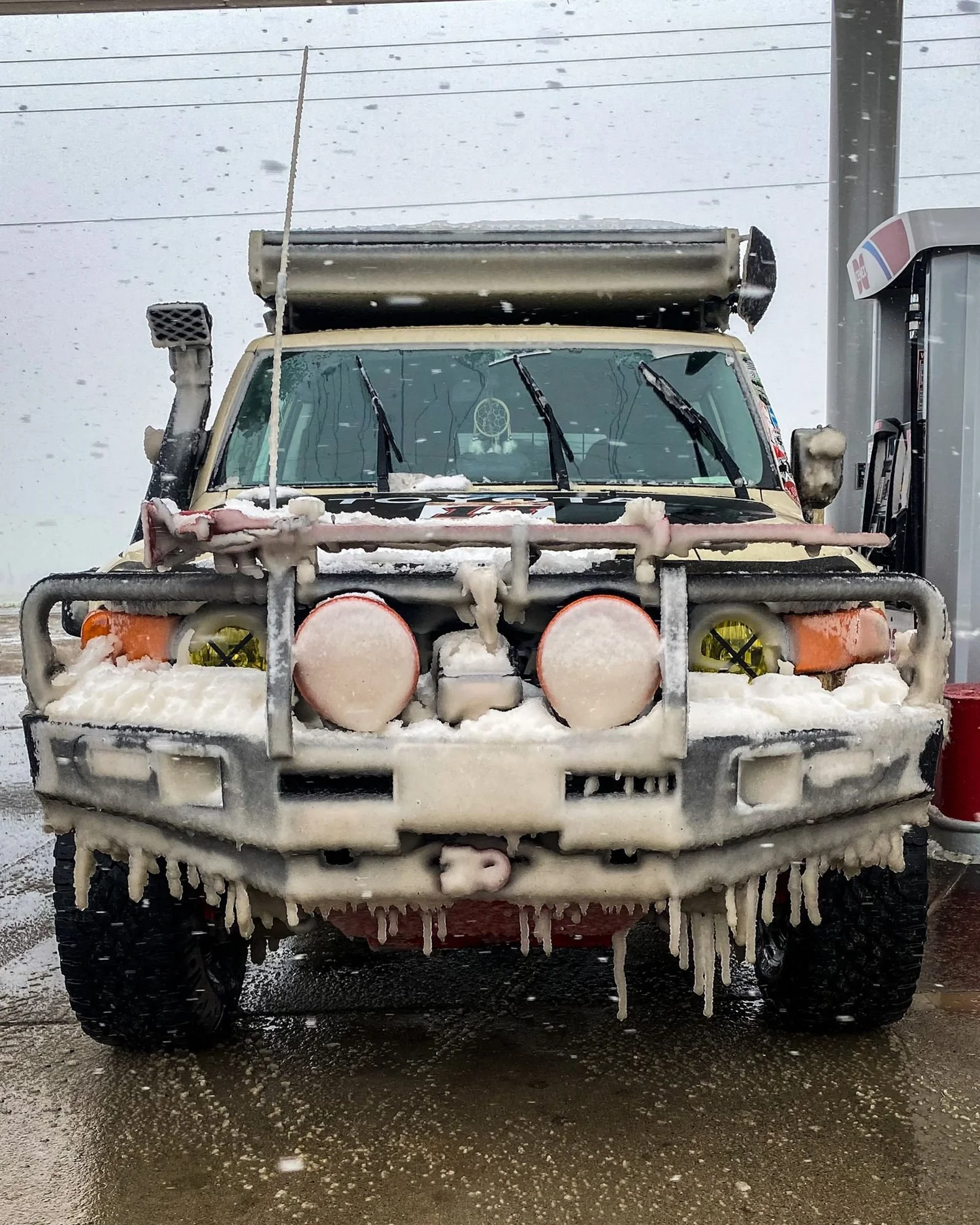 Front of a Toyota FJ Cruiser with icicles and frozen mud hanging from its bumper and lights on a 406 Cruisers run in the upper Ruby River country, Montana