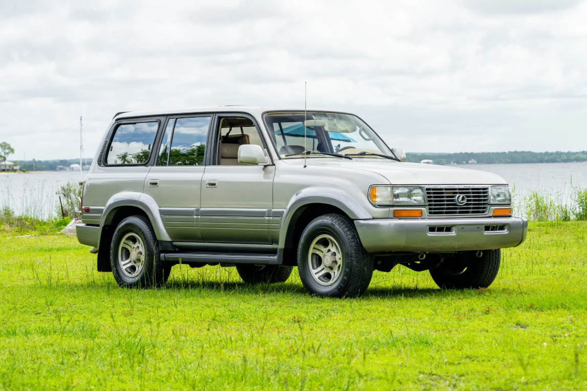 Cashmere Beige 1997 Lexus LX450 parked on grass near water in Milton, Florida