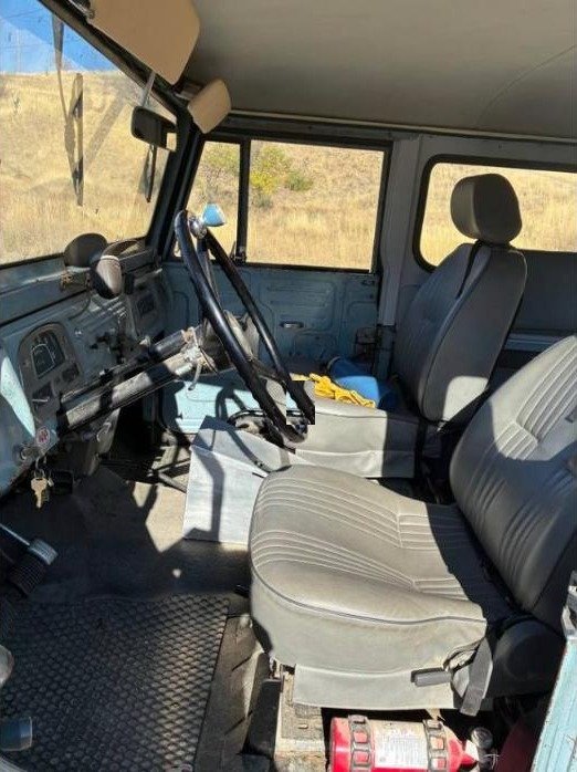Interior of the 1967 FJ40 with gray front bucket seats and a column-mounted shifter
