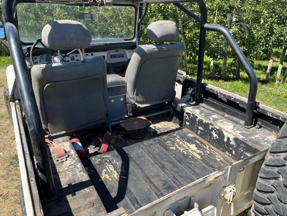Rear tub and gray front seats of the 1969 Toyota FJ40 with a roll bar