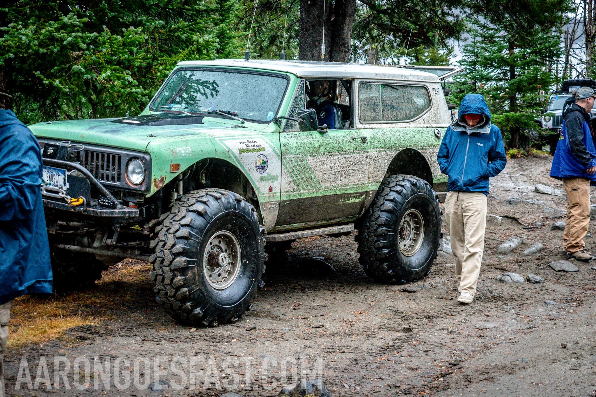 Mud-caked green International Scout on the trail