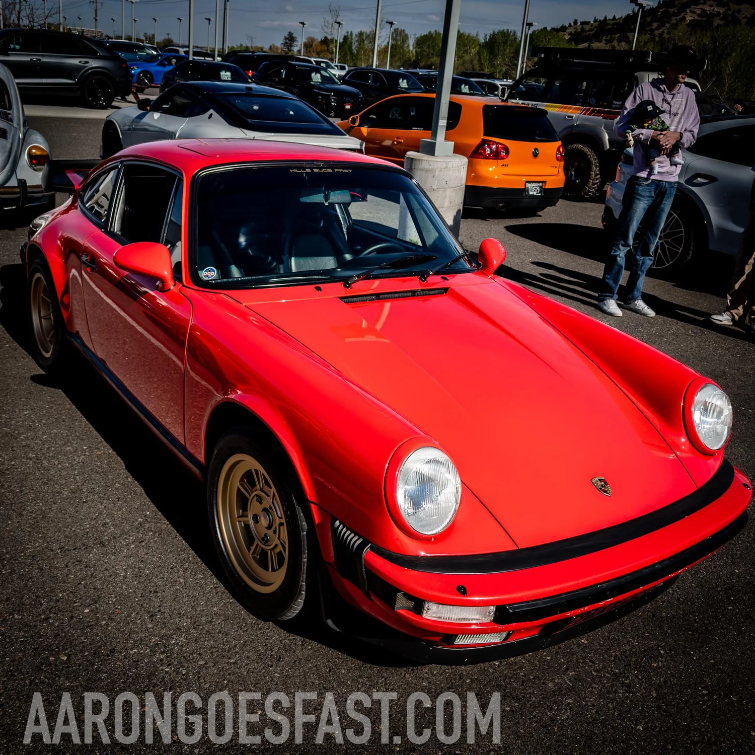 Red Porsche 911 coupe on gold wheels