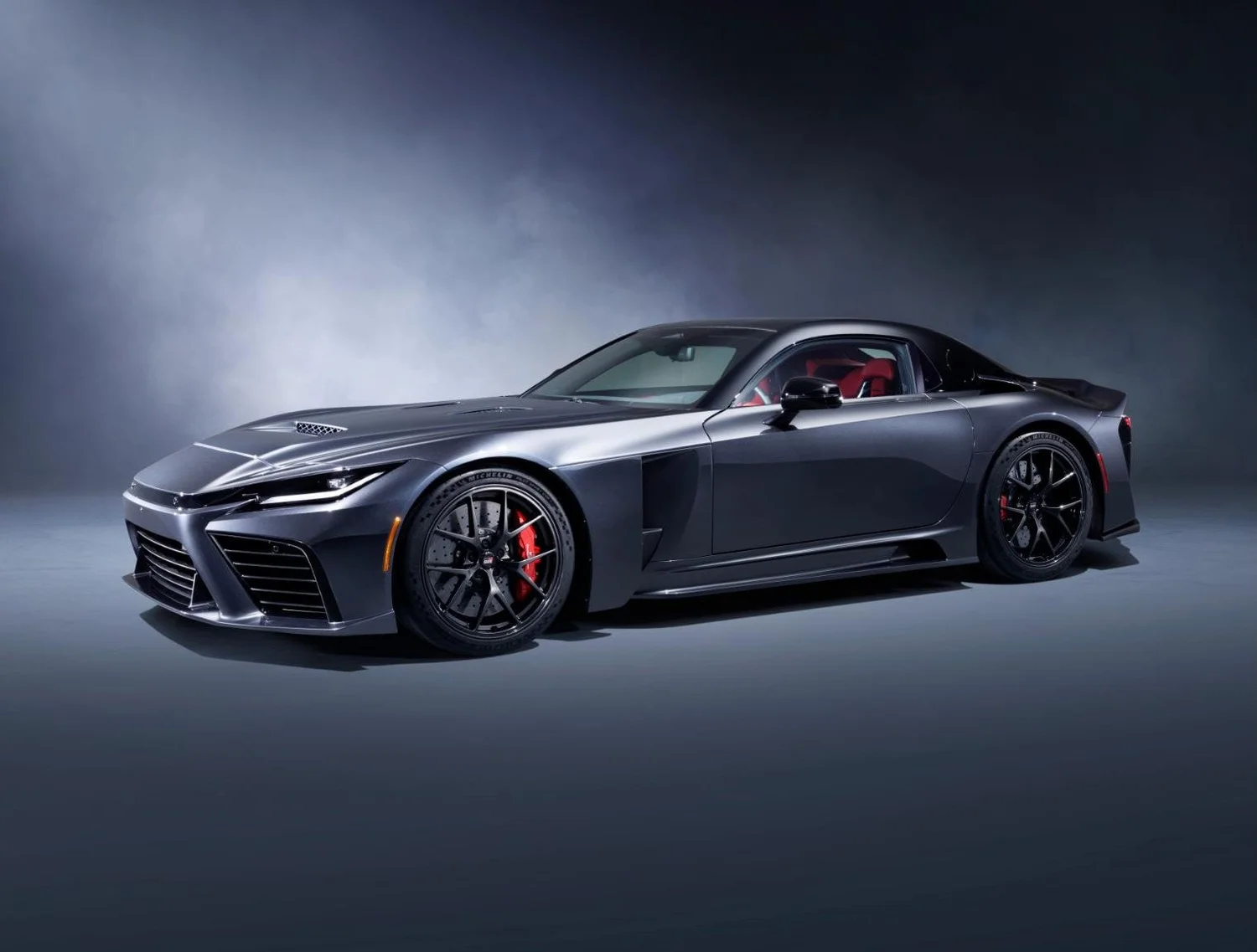Dark gray Toyota GR GT V8 hybrid sports car prototype in a studio