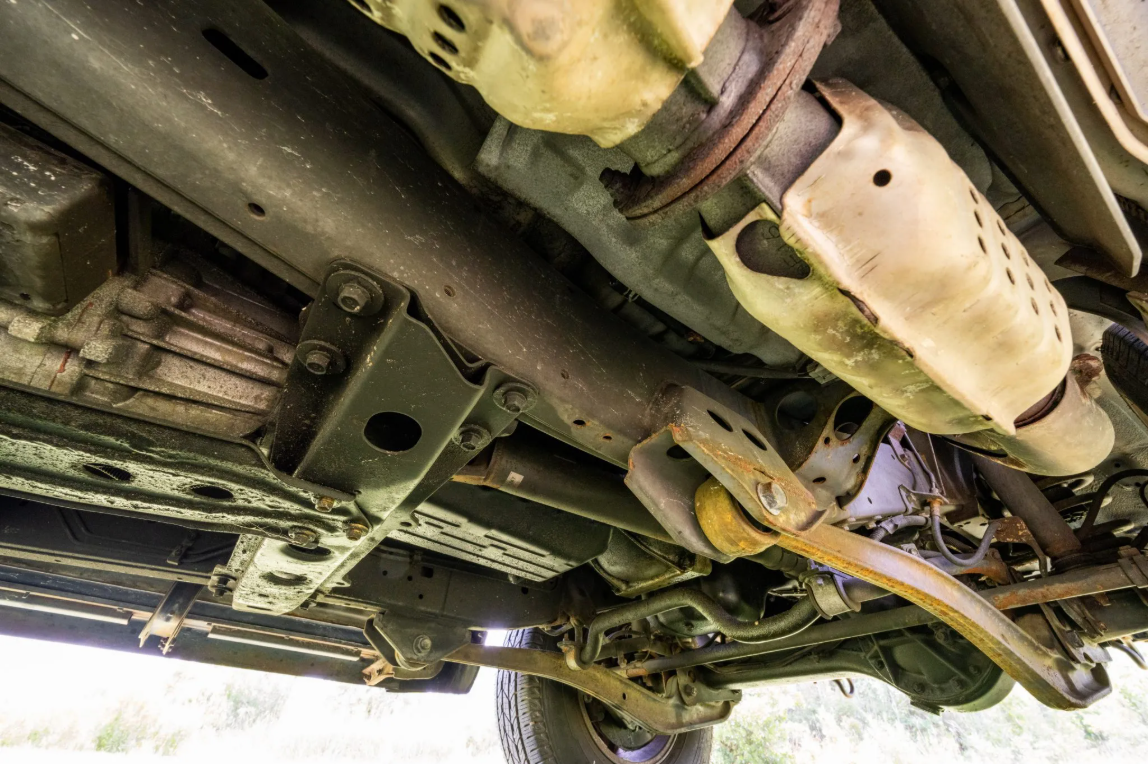 Underside of the 1997 Lexus LX450 showing frame corrosion and exhaust heat shields