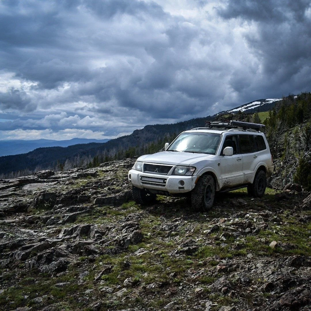White Montero on a rocky slope under dark storm clouds in the Elkhorn Mountains near Boulder, Montana