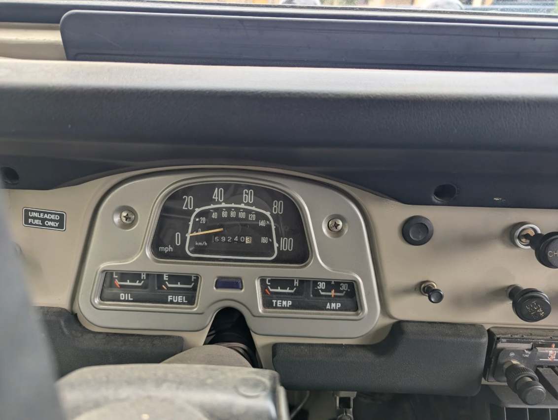 Dashboard gauges of the 1977 Toyota FJ40 showing 59,240 miles