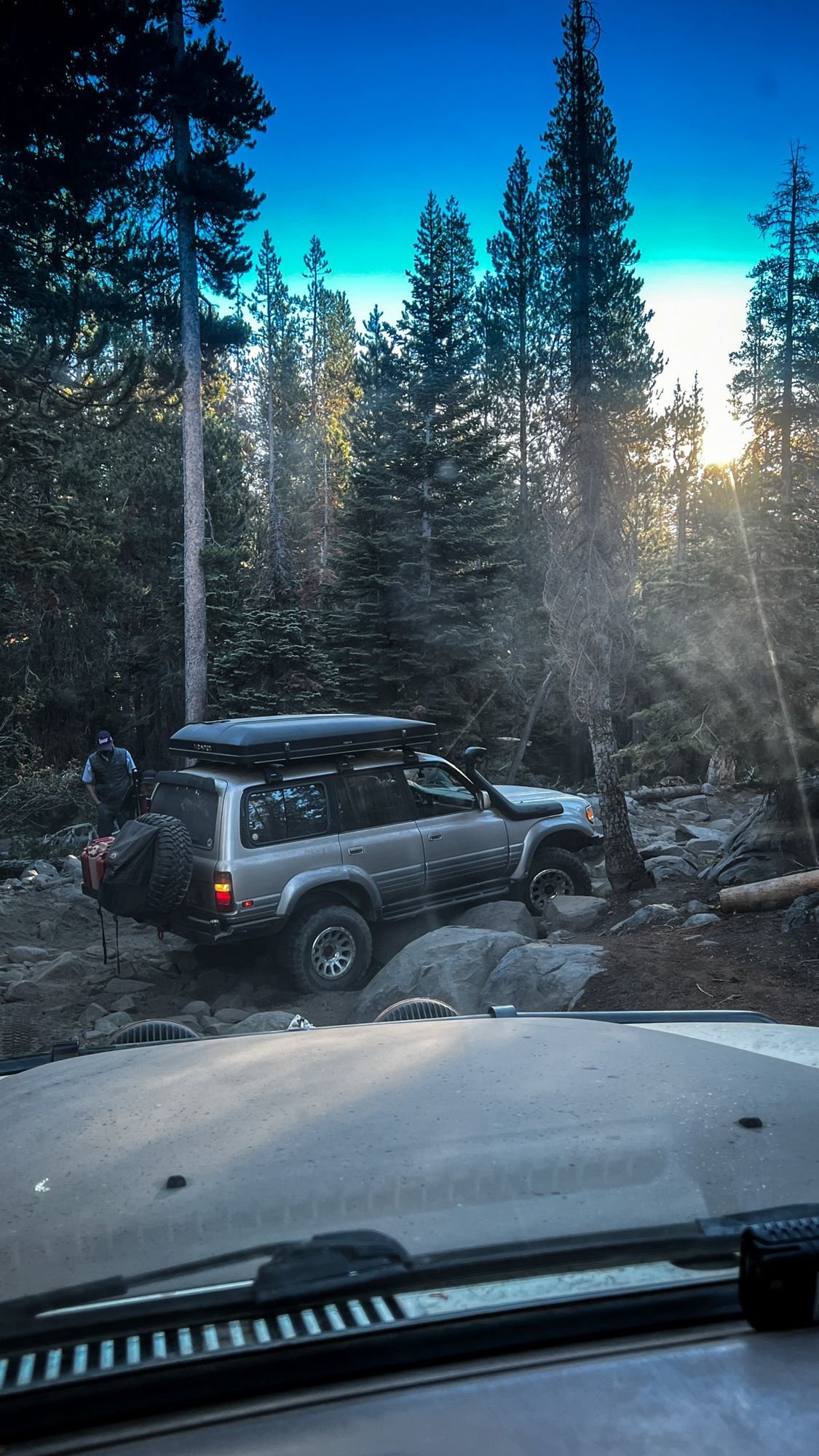Truck on a granite trail with morning sun streaming through the pines on the Rubicon Trail in California during Rubithon 2022