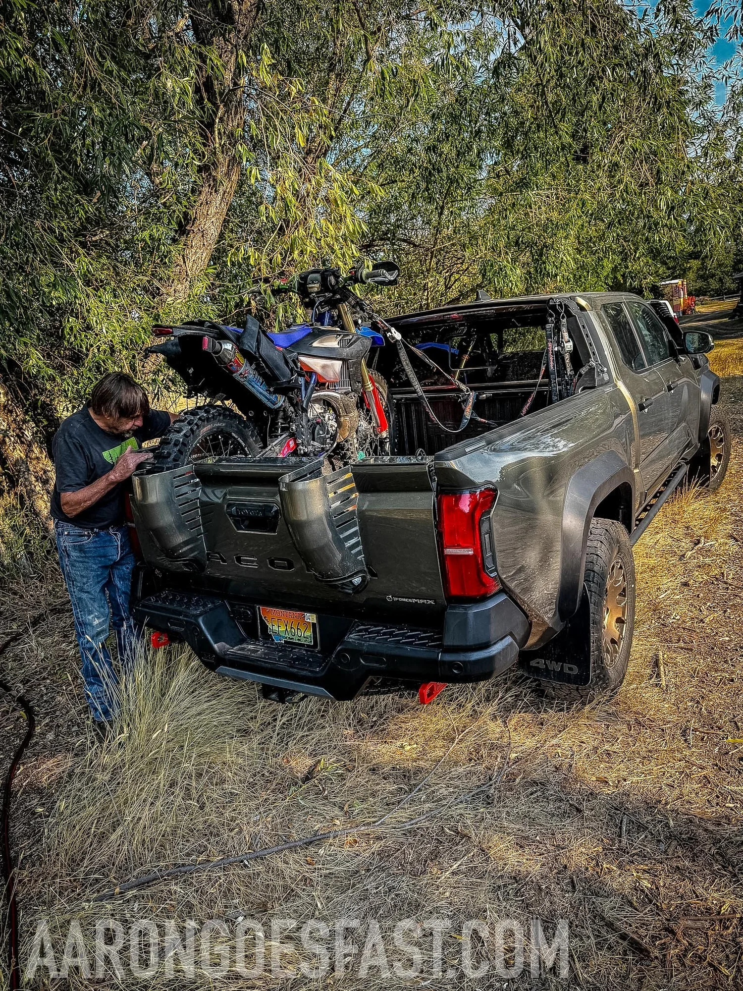 Tacoma Trailhunter with a dirt bike loaded in the bed