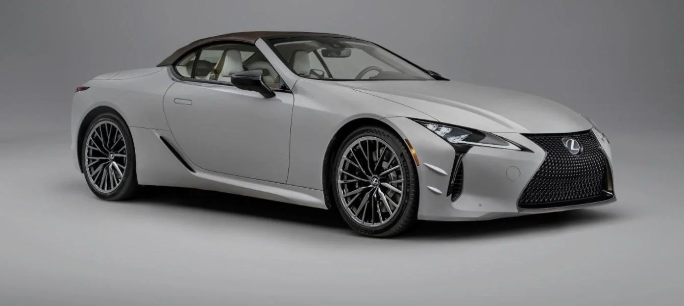 Light gray 2026 Lexus LC 500 Convertible with its brown soft top raised in a studio