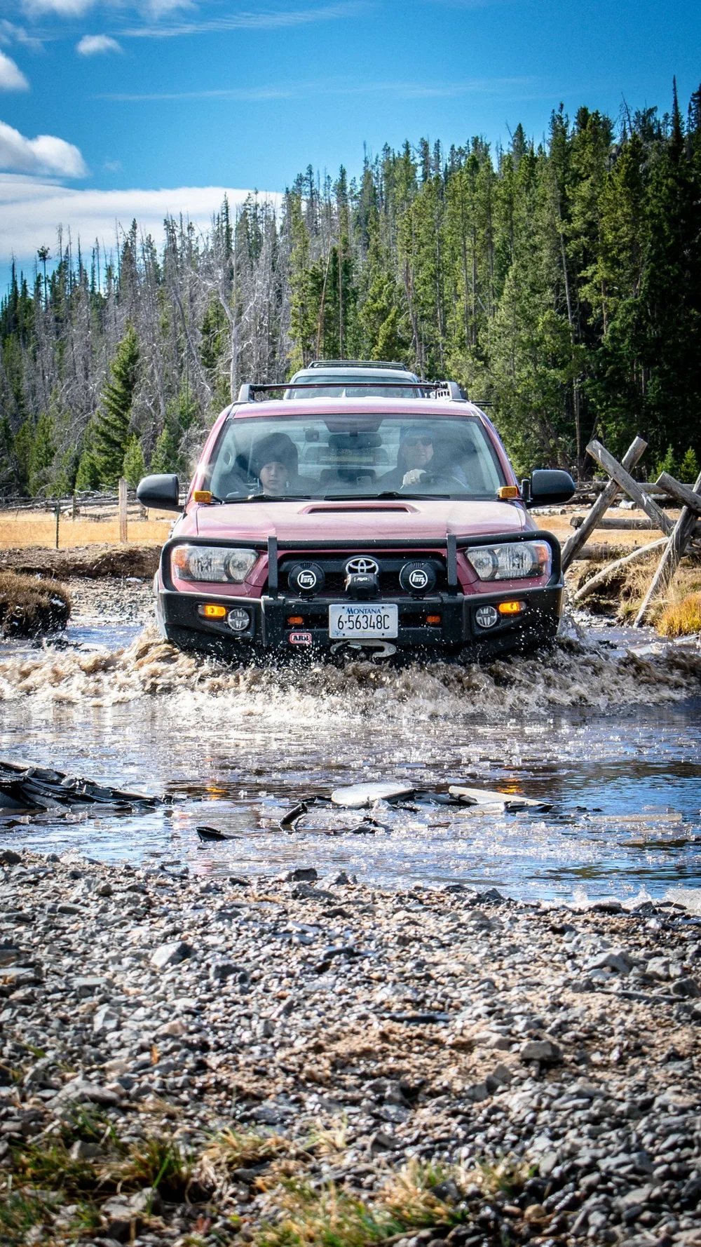 Toyota 4Runner splashing through a shallow creek crossing